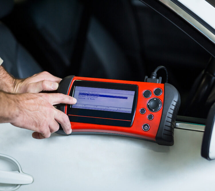 hands-mechanic-using-diagnostic-tool